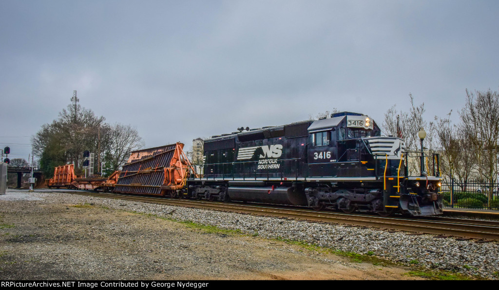 NS 3416 is pulling a section of track by the AMTRAK station